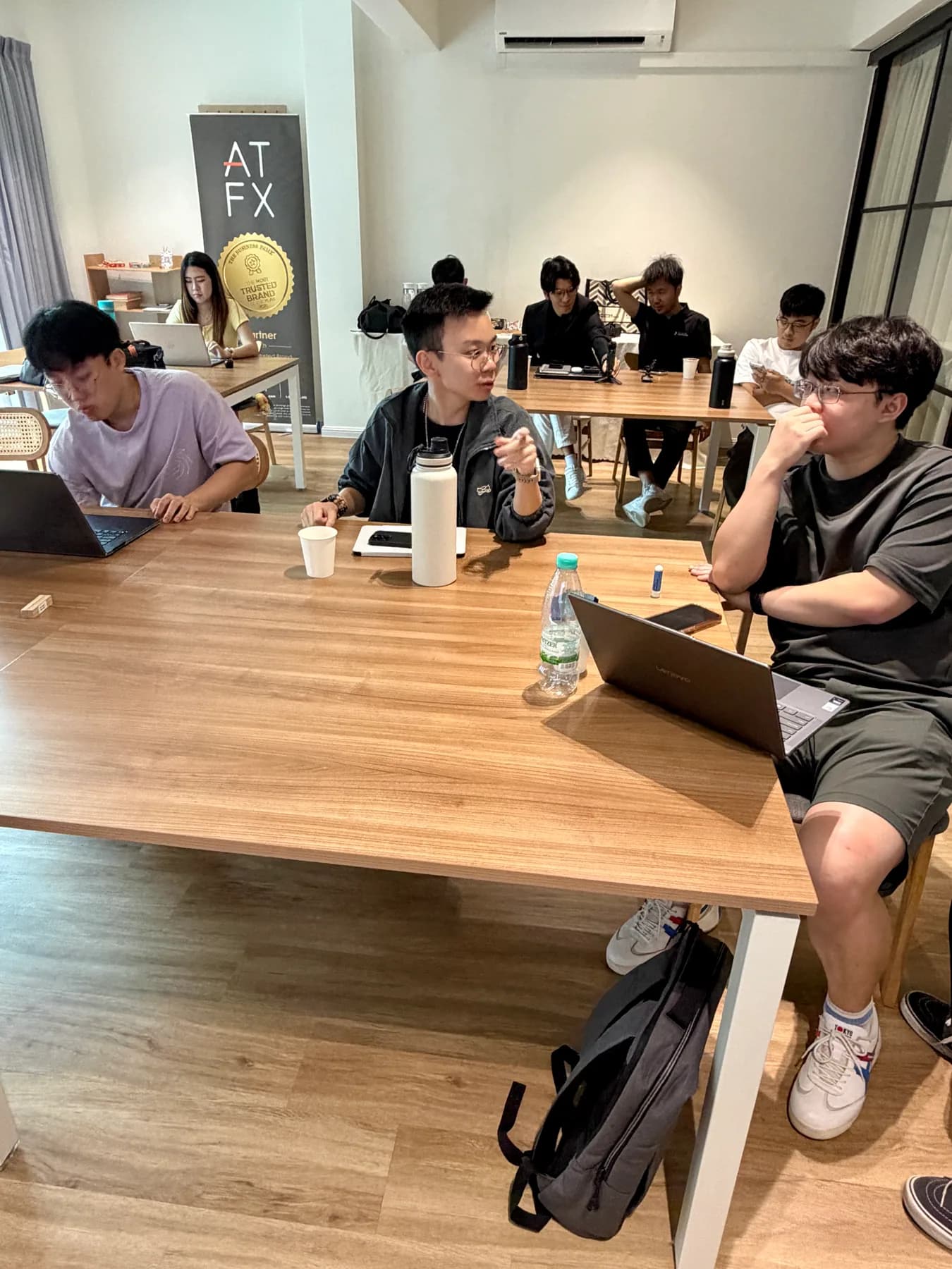 Aeora Trader Development participants discussing market work in small groups