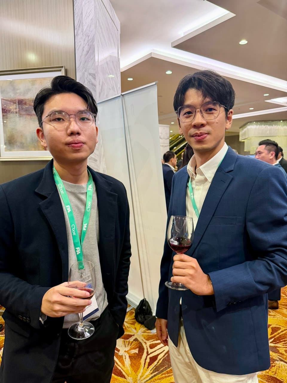 Two attendees wearing FIA Forum 2026 lanyards